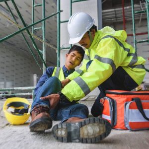 Accident at work of construction worker at site. Builder accident falls scaffolding on floor, Safety team helps employee accident. Add zoom filter effect for movement feeling.